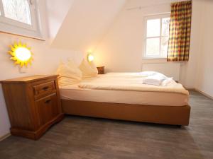 a small bedroom with a bed and a window at Ferienhaus in Wernigerode mit Innenpool in Wernigerode +16 photos