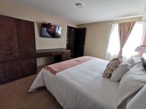 Postel nebo postele na pokoji v ubytování Saint George Hotel - Spa & Temazcal