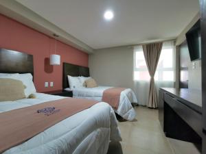Postel nebo postele na pokoji v ubytování Saint George Hotel - Spa & Temazcal