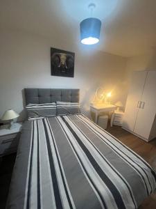 a bedroom with a large bed with a blue light at Luxury Chic Apartments in Liverpool