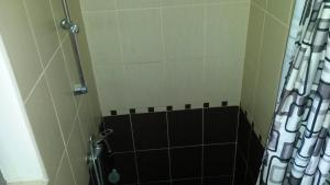 a shower with a black and white shower curtain at Pensiunea Adi Sapinta in Săpânța