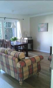 a living room with a couch and a table at Liebevoller Landhaustraum in Ratekau