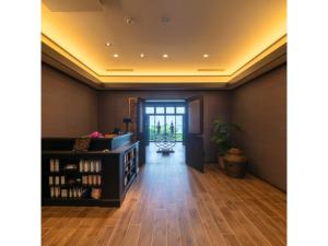 a hallway with a door leading to a room with wood floors at Miyakojima Kurima Resort Seawood Hotel - Vacation STAY 16228v in Uechi