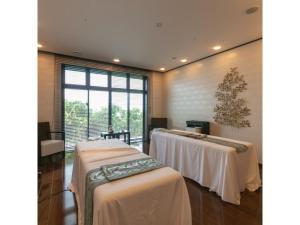 a room with two tables with white table cloths at Miyakojima Kurima Resort Seawood Hotel - Vacation STAY 16229v in Uechi +71 photos