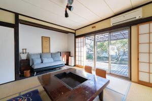 a living room with a table and a couch at Garden Villa Yugawara Kajiya - Vacation STAY 23110v in Mongawa