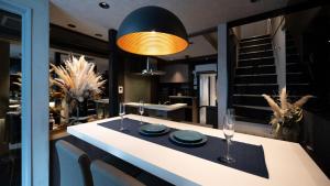a dining room with a table with plates and glasses at trive ozone - Vacation STAY 25323v in Nagoya