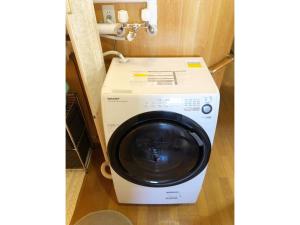 a washing machine in the corner of a room at Guest House Nusa - Vacation STAY 12651 in Kushiro