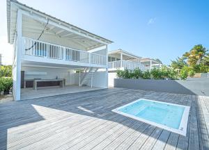 una casa con piscina en una terraza de madera en Picuas Village, en Río Grande