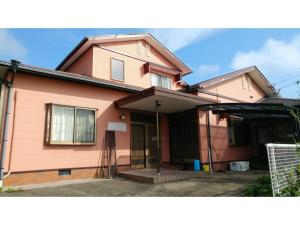 a pink house with the front of it at Asobiyahouse Iki - Vacation STAY 30422v in Iki