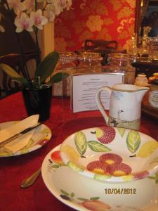 a plate with fruit on it sitting on a table at Cames Mead Farmhouse Bed and Breakfast in Mare Green