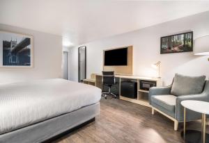 a hotel room with a bed and a desk and chair at Best Western Portland West Beaverton in Portland