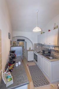 a kitchen with white cabinets and a counter top at Galini Apartments Old Town in Rhodes Town