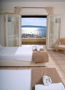 a bedroom with a large bed and a view of the ocean at Bellina Villa in Agnítsini