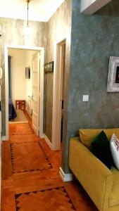 a living room with a couch and a hallway at The sunset Lisbon flat in Lisbon