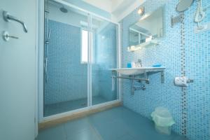 a blue tiled bathroom with a shower and a sink at Il Cortile delle Esperidi in Lecce +131 photos