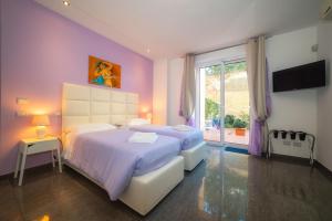 a bedroom with two beds and a large window at Il Cortile delle Esperidi in Lecce