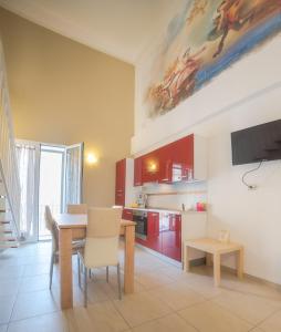 a kitchen with a table and a dining room at Il Cortile delle Esperidi in Lecce
