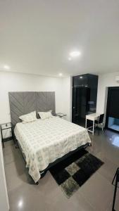 a bedroom with a large bed and a table at Ergosuites in Figueira da Foz