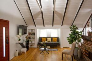 a living room with a couch and a table at Dreamy Farmhouse in Studio City in Los Angeles