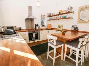 a kitchen with a wooden table and chairs at Rose Cottage in Bakewell +10 photos