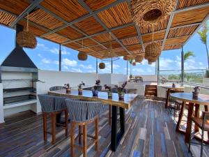 a dining room with a large wooden table and chairs at Casa Elda in Tulum