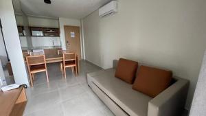 ein Wohnzimmer mit einer Couch und einem Tisch mit Stühlen in der Unterkunft Salinas Premium Resort in Salinópolis