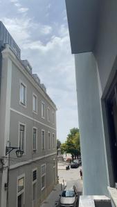 a building with a car parked next to a street at Ergosuites in Figueira da Foz