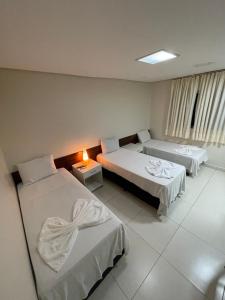 Кровать или кровати в номере Aldeia das Flores Hotel
