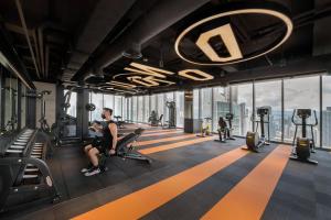 a man sitting on a treadmill in a gym at Capri by Fraser, Bukit Bintang in Kuala Lumpur