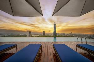 a rooftop pool with a view of a city skyline at Capri by Fraser, Bukit Bintang in Kuala Lumpur