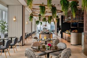 a restaurant with tables and chairs and a bar at Capri by Fraser, Bukit Bintang in Kuala Lumpur