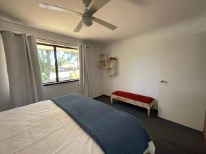 a bedroom with a bed and a window at Siroque Busselton in Busselton
