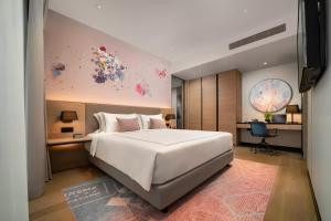 a bedroom with a large white bed and a desk at Capri by Fraser, Bukit Bintang in Kuala Lumpur +35 photos
