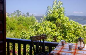 a table on a balcony with a view of the water at Mount Joy Cottages in Knysna