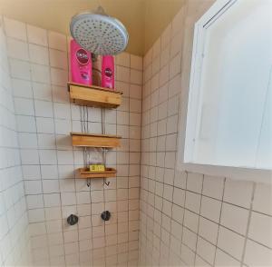 a bathroom with a shower with pink shampoo at Miraflores Dpto 2 dorm. espaciosos 4 huéspedes 90m2 in Lima
