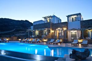 a pool in front of a villa at night at Niriides Homes & Villas in Elia Beach