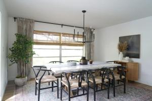 a dining room with a white table and chairs at Remodeled 4BR Pool Home / Golf View/Near Beaches in Sarasota