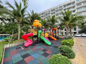 a playground with a colorful play equipment in front of a building at LAGUNA BEACH 3 MALDIVES in Jomtien Beach