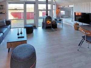 a living room with a couch and a fireplace at 6 person holiday home in Hemmet in Hemmet