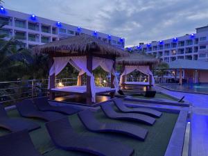a resort with lounge chairs and a gazebo at LAGUNA BEACH 3 MALDIVES in Jomtien Beach