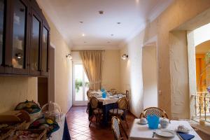 a kitchen with a table and a dining room at Albergo del Lago in Capalbio