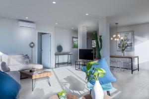 a living room with a couch and a tv at Atico Puerto Sol in Altea