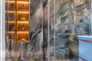 a bathroom with a shower with a glass door at Atico Puerto Sol in Altea +21 photos