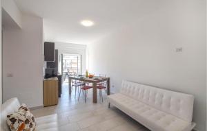 a living room with a white couch and a table at Gorgeous Apartment In Nicotera Marina in Nicotera Marina