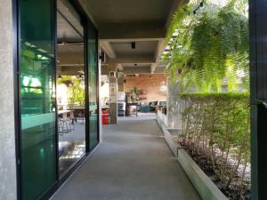 an empty hallway in a building with plants at Elite Residence Phitsanulok SHA in Phitsanulok