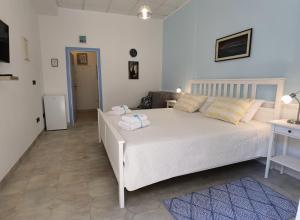 a bedroom with a large white bed with towels on it at RIO B&B, 5 stars SUPERIOR room, near the sea and park in Novigrad Istria