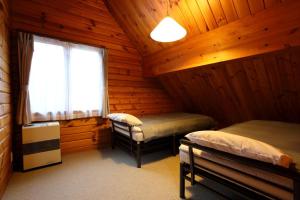 Postel nebo postele na pokoji v ubytování Hakuba Happo Log Chalets