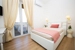 A bed or beds in a room at Viale Italia Boutique Rooms