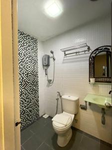 a bathroom with a toilet and a sink at Rae Hotel Bukit Bintang in Kuala Lumpur