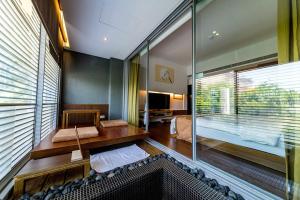 a room with a large glass window and a bedroom at Hotel Double One in Taipei
